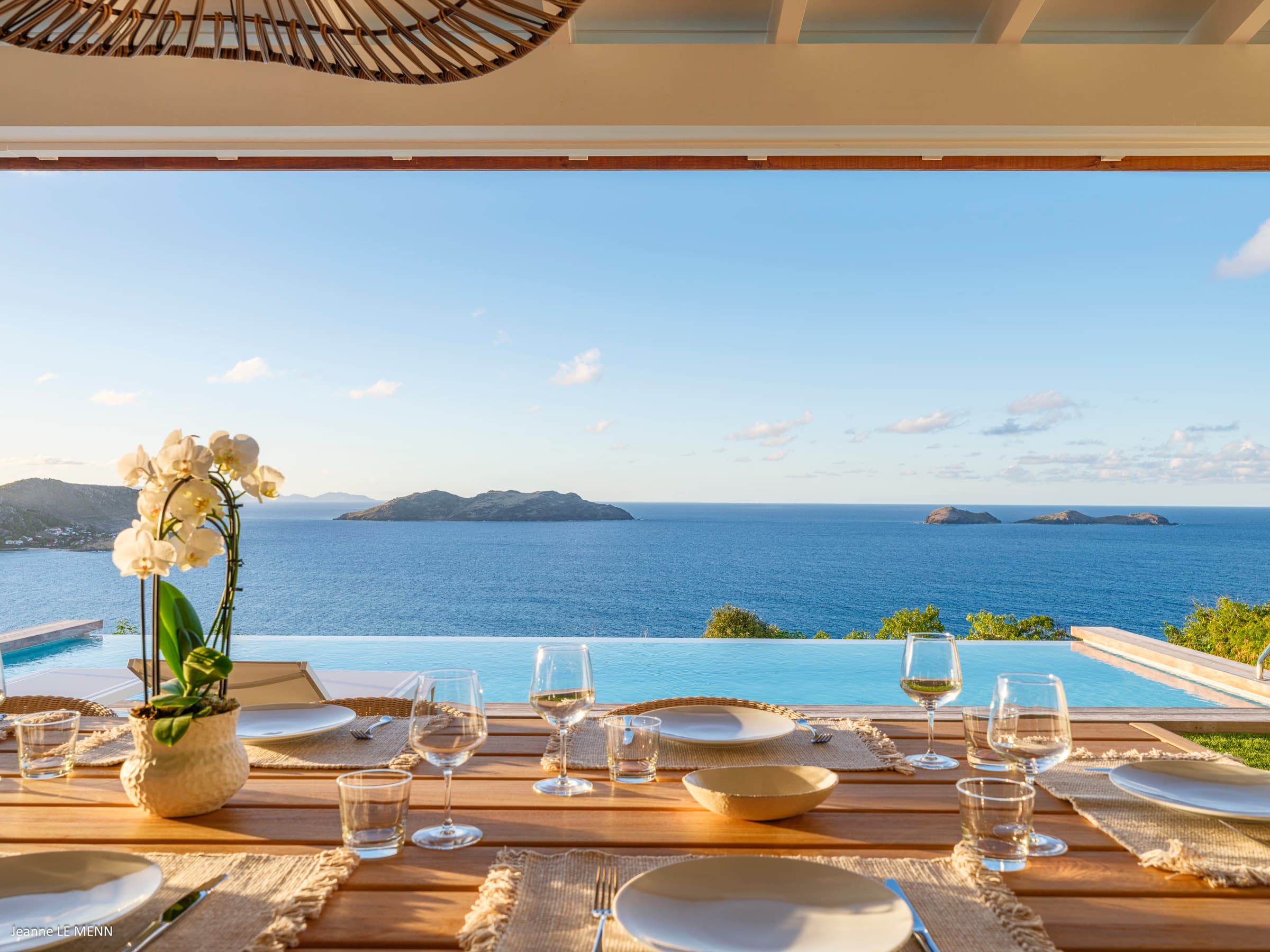 Patio dining area with pool in the background